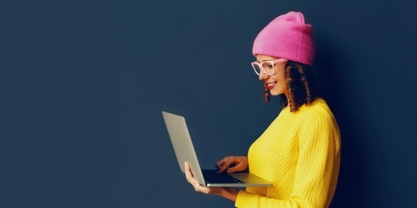 Lady wearing glasses using a laptop computer