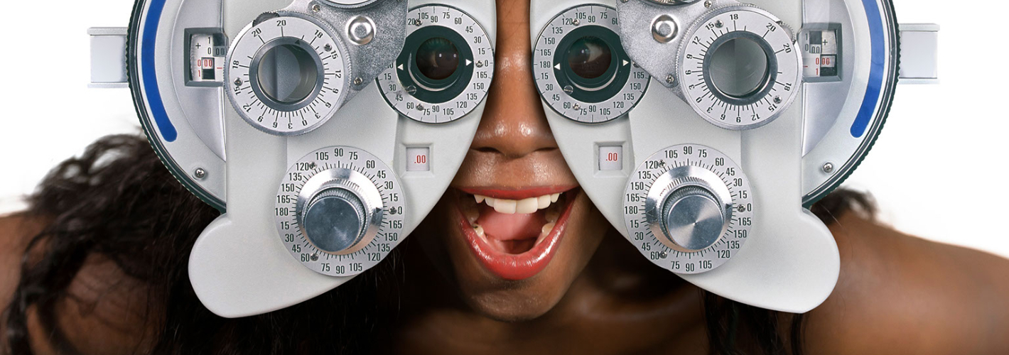 woman looking through optometric hospital device checking eyes having sight exam in ophthalmology health