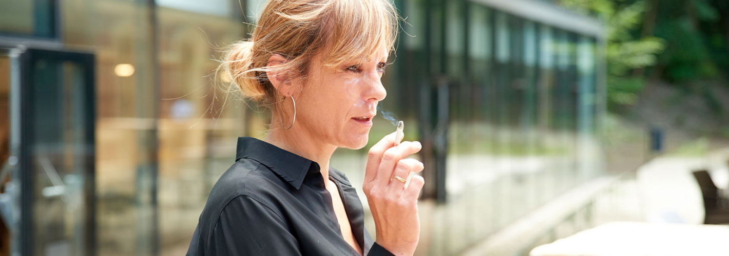 Middle aged woman smoking cigarette